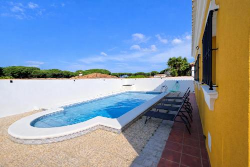 a swimming pool on the side of a building at Casa oasis de chiclana in Novo Sancti Petri