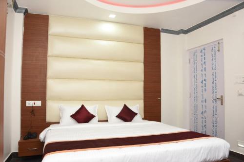 a bedroom with a large bed with a wooden headboard at Sea Shore In in Port Blair