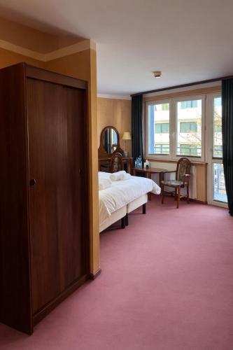 a bedroom with a bed and a large window at Apartamenty Port 111 in Kołobrzeg