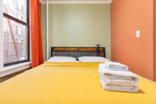 a bedroom with a bed with towels on it at 2 Bedroom Home Unit In Lower Manhattan in New York