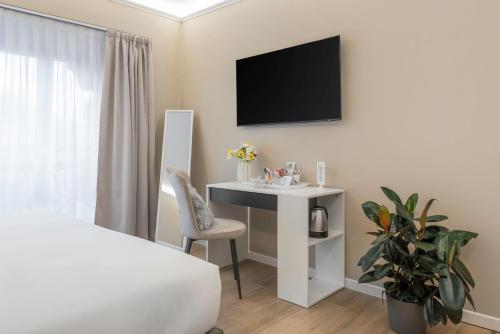 a bedroom with a bed and a desk and a tv at B&B Le Stanze del Duomo in Florence
