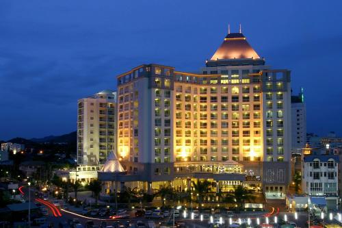 a large building with a dome on top of it at Cape Racha Hotel in Si Racha