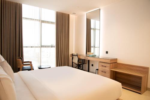 a bedroom with a bed and a desk and a mirror at Hafawah Resort in Medina