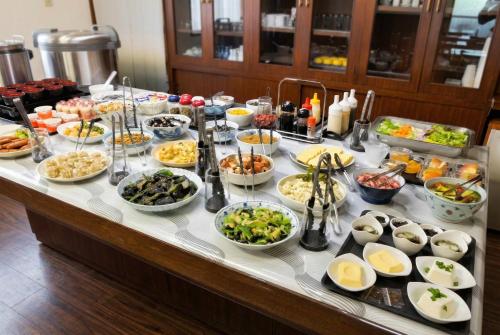 a buffet with many dishes of food on a table at Hotel Sincerity kani in Kani