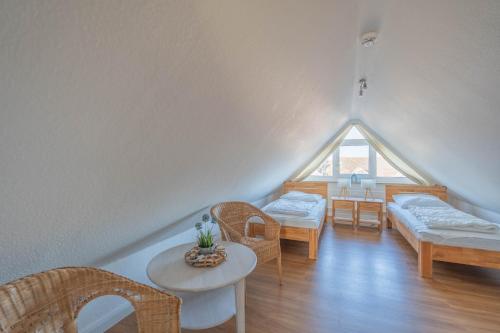 a room with chairs and a table and a window at Küstenglück in Neustadt in Holstein