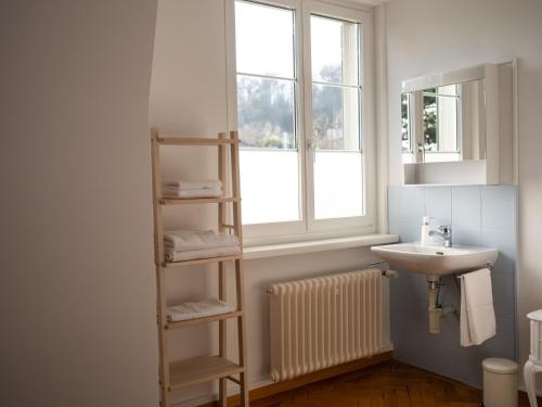 a bathroom with a sink and a toilet and a window at B&B Zoo Caffè & Ristorante in Zurich