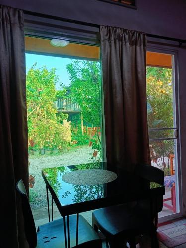 a table in front of a window with a view of a yard at Six Nature Resort in Chiang Rai