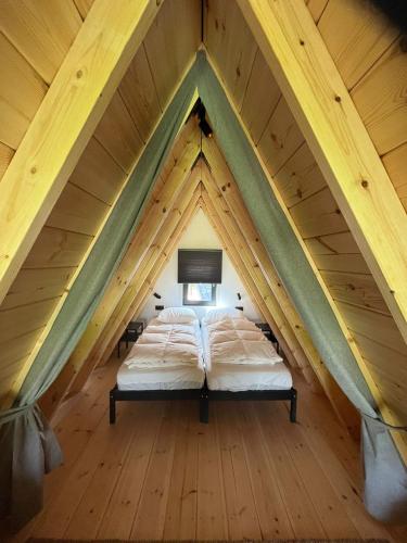 a bed in the middle of a attic at Parc Sonnleiten - A Chalet in Gnesau