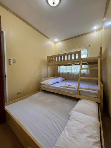 a bedroom with two bunk beds in a room at Nielo's Apartment Door 5 in Dapitan