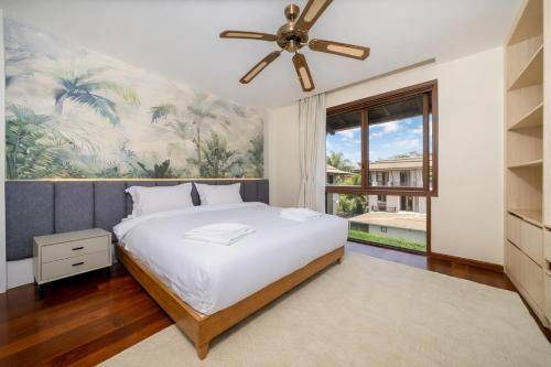 a bedroom with a bed and a ceiling fan at 4BR Penthouse Royal Marina 6B Private Rooftop Pool with 360 View in Phuket