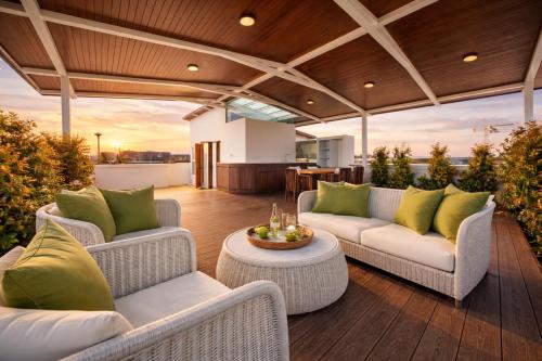 a patio with couches and a table on a deck at 4BR Penthouse Royal Marina 6B Private Rooftop Pool with 360 View in Phuket