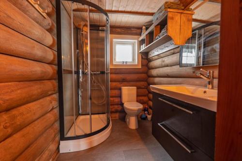 a bathroom with a shower and a toilet and a sink at Meraftahornvegen 36 in Stranda
