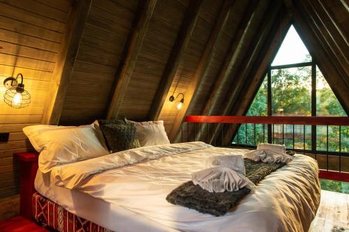 a bed in a room with a large window at Hai La Munte Bran in Bran