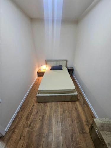 a bedroom with a bed in the corner of a room at Tbilisi- Georgia in Tbilisi City