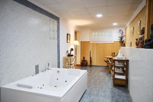 a large bathroom with a tub and a table at Hotel Tossal d'Altea in Altea