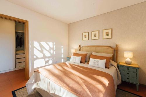 a bedroom with a large bed with two pillows at Casas da Memória in Tarouca