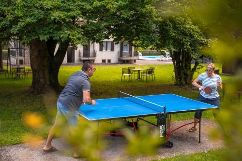 two people playing ping pong on a ping pong table at Residence CATULLO in Bezzecca