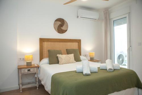 a bedroom with a large bed with two pillows at Casa Mari Pepa beach & pool in Benajarafe