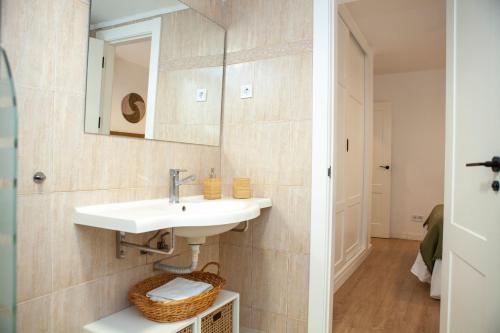 a bathroom with a sink and a mirror at Casa Mari Pepa beach & pool in Benajarafe