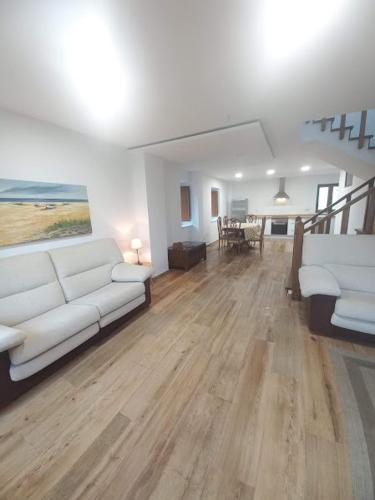 a living room with a white couch and a table at Lar da avoa in Ouviaña