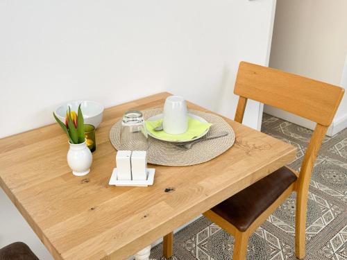 a wooden table with a plate and a candle on it at Heilotel in Heilbad Heiligenstadt