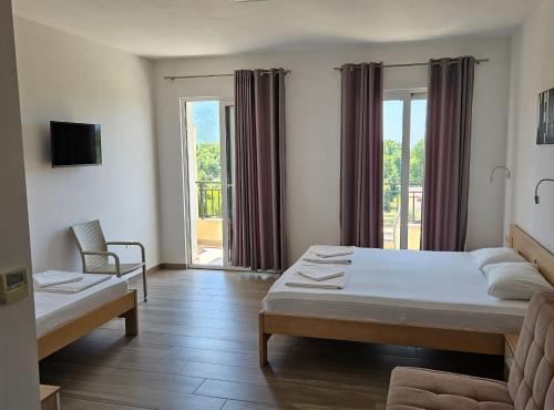 a bedroom with a bed and a couch and a window at Villa Ponta in Kaluđerac