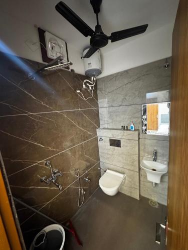 a bathroom with a toilet and a sink at Hotel HB Grand in Anūpgarh