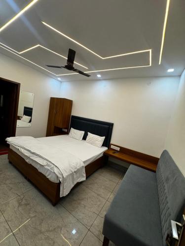 a bedroom with a bed and a ceiling at Hotel HB Grand in Anūpgarh