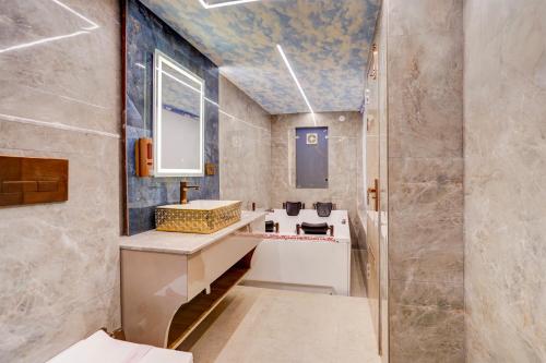 a bathroom with a sink and a shower at Hotel Armani Suites-Free Airport Drop in New Delhi