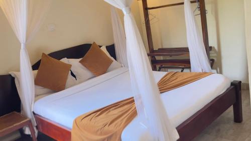 a bedroom with two beds with mosquito nets at Safari Homes in Kampala