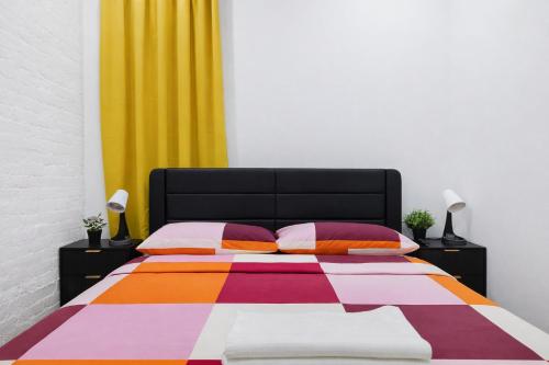 a bedroom with a bed with a colorful blanket at 2 Bedroom Modern Unit in Central Manhattan in New York