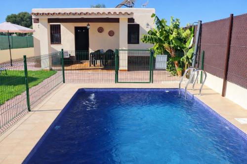 a swimming pool in front of a house at Casa Lucia Conil in Conil de la Frontera