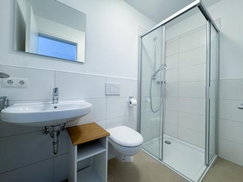 a bathroom with a toilet sink and a shower at A2 Hotel Memmingen - SELF-CHECK-IN in Memmingen