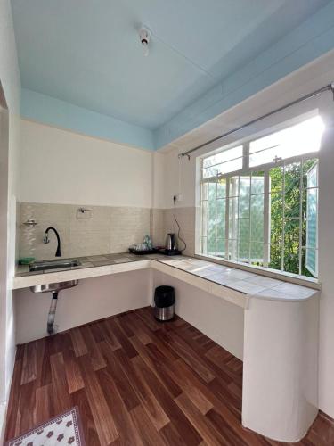 a kitchen with a sink and a window at Spring Grove B&B in Jowai