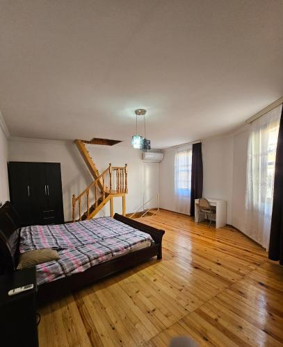 a bedroom with a bed and a wooden floor at Home in Ancient District in Tbilisi City
