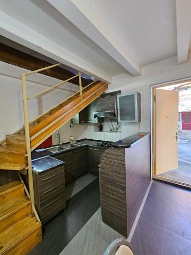 a kitchen with a staircase in a room at Home in Ancient District in Tbilisi City