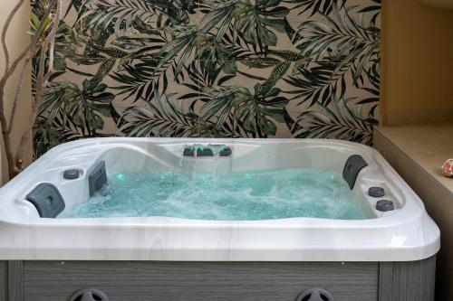 a bath tub with water in it in a bathroom at Olea Blue Suite in Stalís