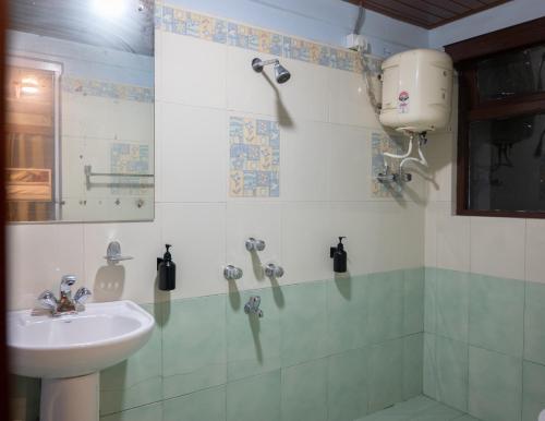a bathroom with a sink and a shower at Trippers CastleWoods in Darjeeling