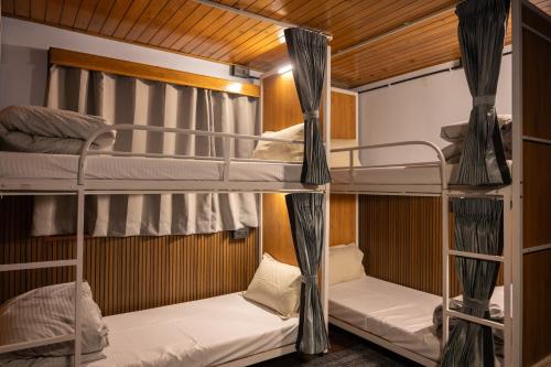 a bunk bed room with two bunk beds in it at Trippers CastleWoods in Darjeeling
