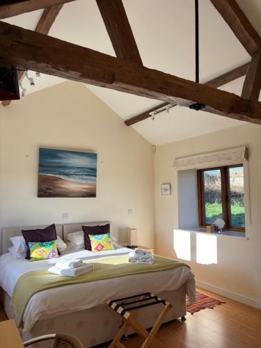 a bedroom with a large bed and a window at Cool Contours Venue in Eydon