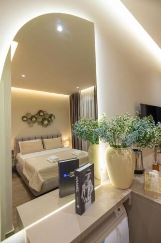 a bedroom with a bed and a large mirror at Del Mare Rooms in Vlorë