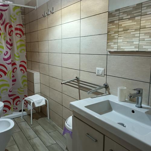 a bathroom with a sink and a toilet at Nonnacettyhouse in Torre del Greco