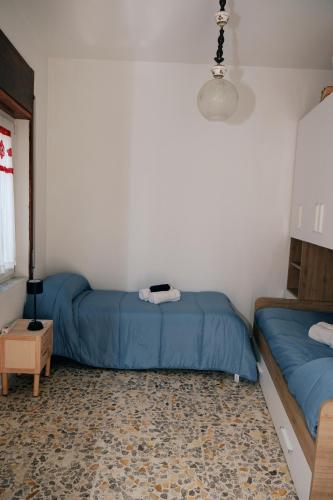 two beds in a room with blue sheets at La terrazza in Contursi