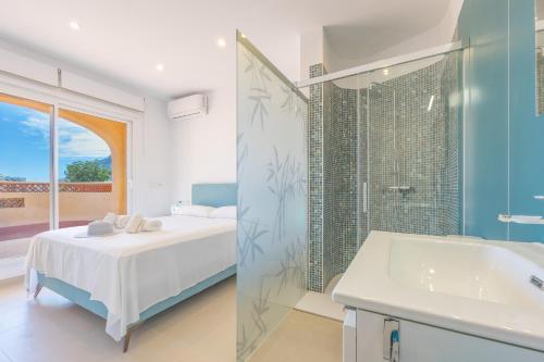 a bathroom with a bed and a shower and a sink at Villa Cronos - PlusHolidays in Ifach