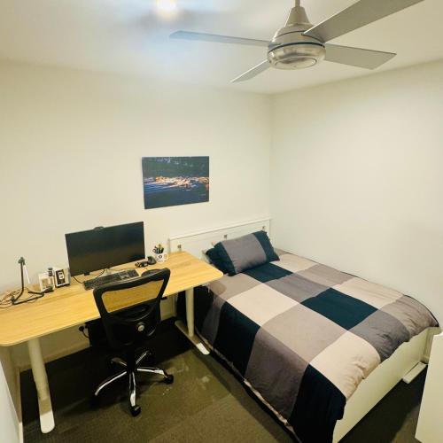 a bedroom with a bed and a desk with a computer at Casa de Burgh in Turner