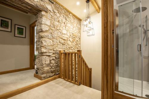 a hallway of a home with a stone wall at Beckside in Kettlewell