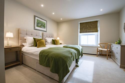 a bedroom with a large bed and a window at Beckside in Kettlewell