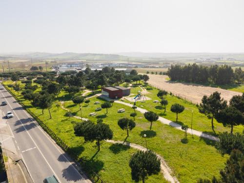 an aerial view of a park with trees and a road at Guesthouse Solar do Mar in Silveira