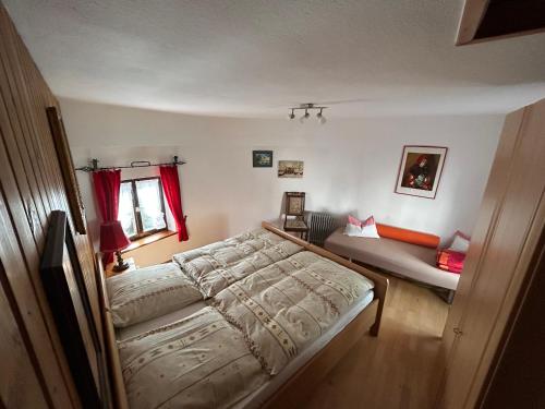 a bedroom with a bed and a couch in it at Turm an der Mauer in Ellwangen