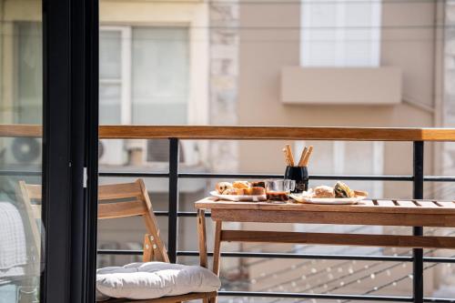 a table with bread and pastries on a balcony at Bedspot Heraklion in Heraklio